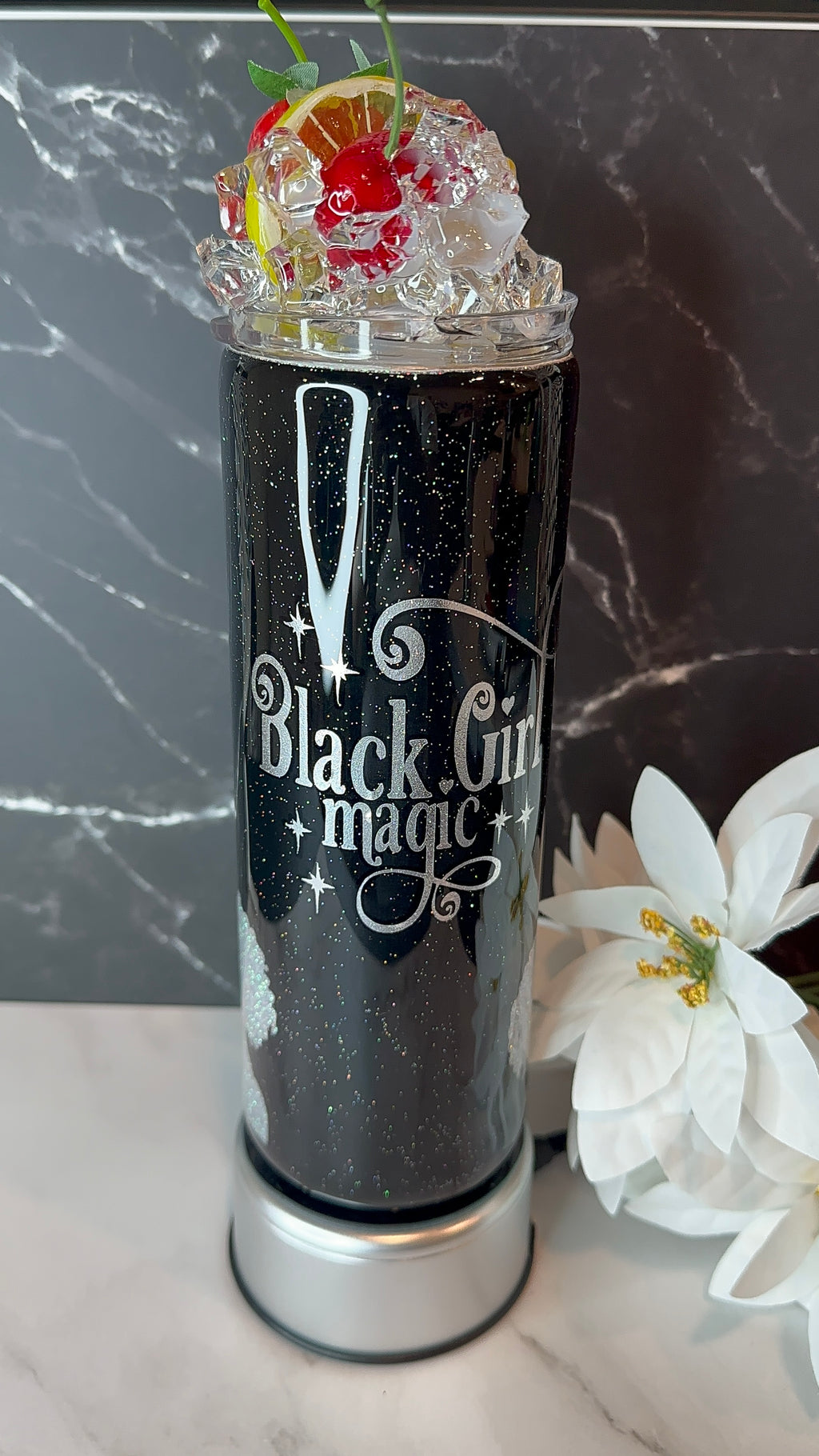 Black Girl Magic cocktail with garnish on a marble surface