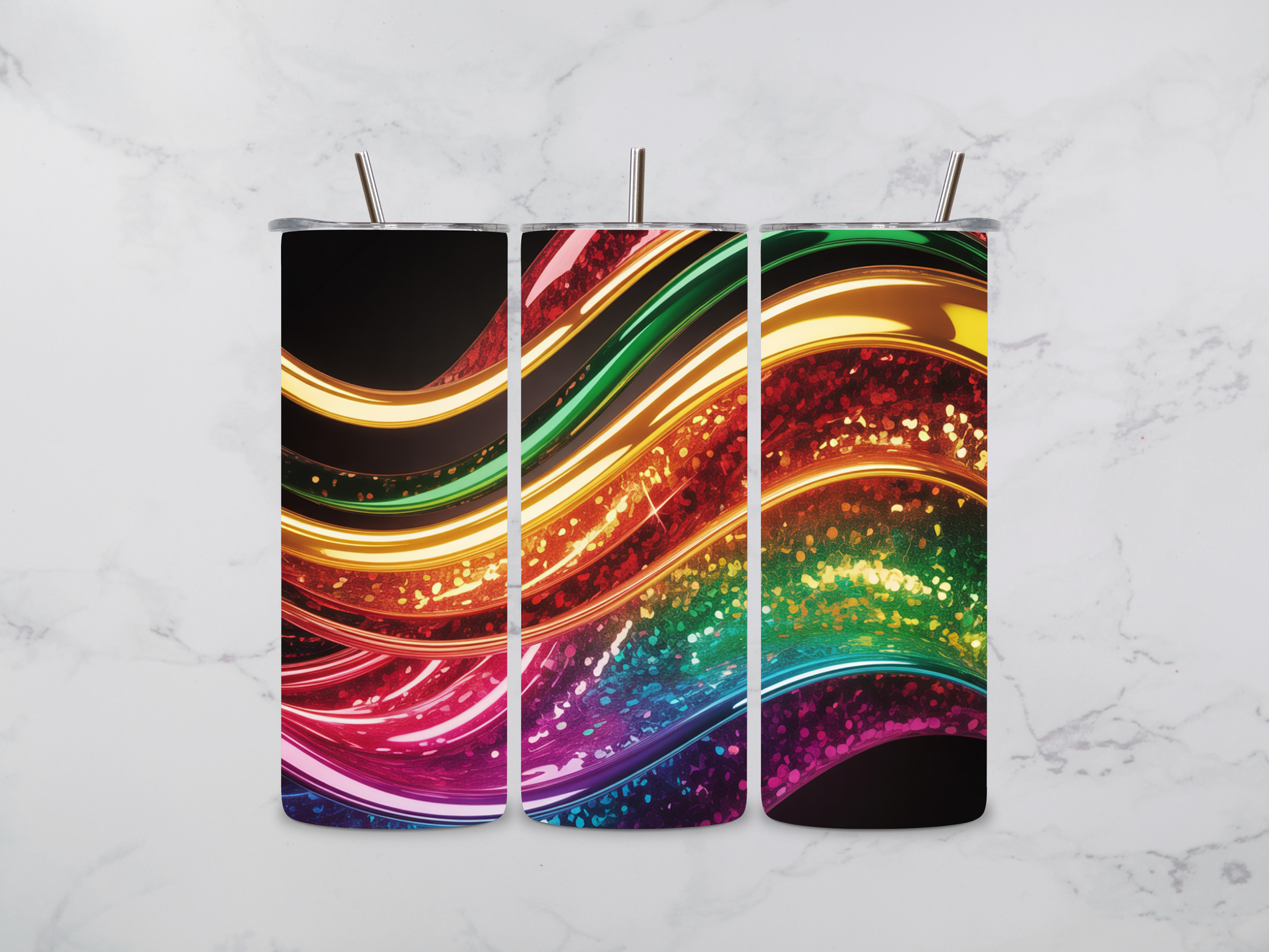 Three colorful tumblers with a gradient design on a marble surface